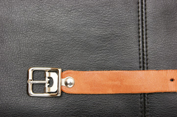 belt  with a buckle on a black leather