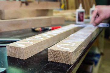 Spreading the adhesive on the bonding surfaces. Joinery