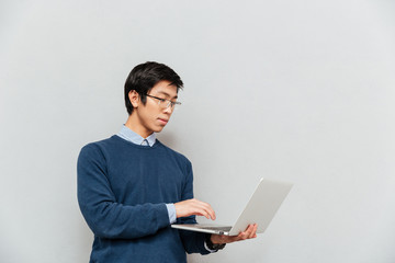Asian man with laptop