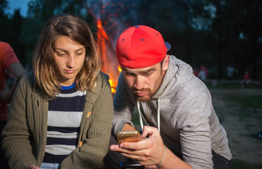 Guy and girl watch mobile