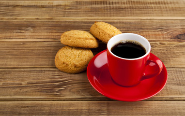 red cup with coffee and cookie