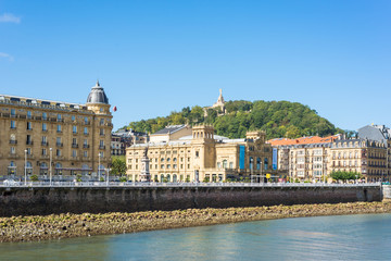 Fototapeta premium View across the river Urumea to the Victoria Eugenia Theater, a neoplateresque building, a special Spanish architecture, in Donostia San Sebastian. 