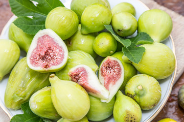 Ripe fig fruits on the wooden table.