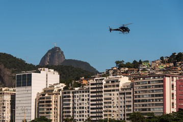 Helicopter flying above buildings in Copacabana and Corcovado, Rio de Janeiro