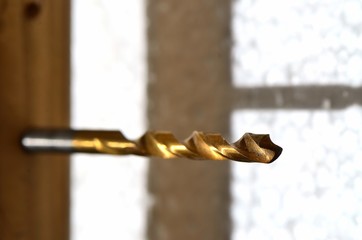 Drill bit  /  Drill bit with the shadow attached to the board. Focus is on the top of bit.