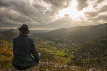 Fototapeta premium young man looking the mountain at sunset