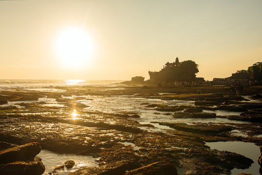 Tanah Lot temple and sea waves in beautiful sunset light, Bali,