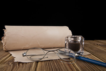 old glasses, paper and pen