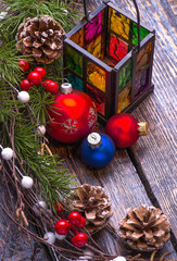 Christmas card with tree decorations and glass candlestick  on th wooden background. Marry Christmas