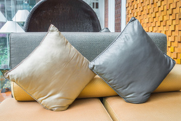 Closeup of modern furniture with pillows .