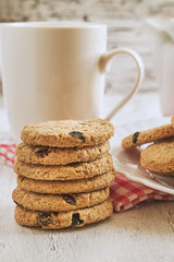 Stack of wholewheat biscuits with raisins on white rustic table