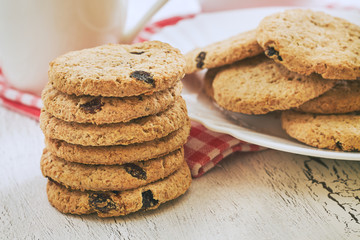 Stack of wholewheat biscuits with raisins on white rustic table