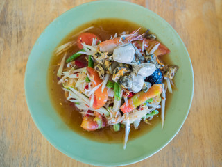 Papaya Salad (Som tum Thai) on wood table.