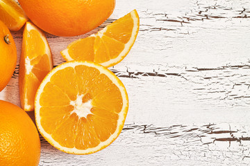 Oranges on white rustic wooden background. Top view with copy space