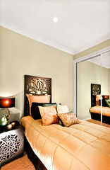 Modern single bedroom closeup focusing the wooden bed included a