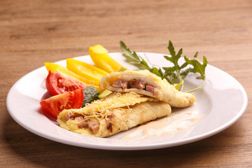Fried asian egg rolls with pepper ant tomato