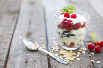 Layered dessert with fruits and cream cheese in glass