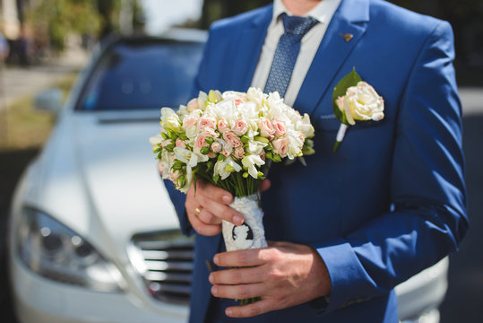Groom with Bouquet at Car