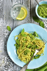 Spaghetti with green peas and basil pesto.