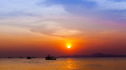 Naklejka na ściany i meble Beautiful landscape. sunset on the beach with fishing boat
