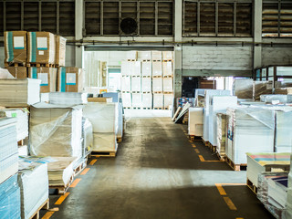 Many plastic packaging of paper in a large warehouse (paper fact