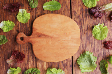 Lettuce different varieties on wooden background.Health life concept. Top view.