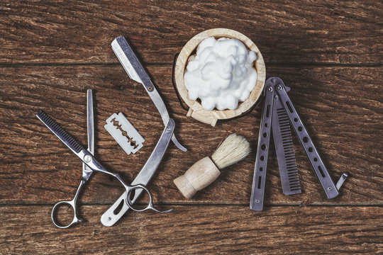 Vintage tools for barber shop on old wood background