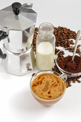 Coffee beans and ground, milk in a bottle, Moka pot