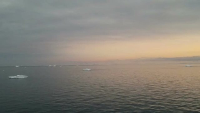 Sunrise over Brabant Island, Gerlache Strait, Antarctica. Brabant island is the second largest island in the Palmer Archipelago. Large ice-cliffs protect its coastline from the sea.