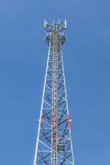 The top of communications tower with blue sky background.