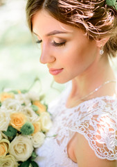 nice portrait of young and beautiful bride in a white dress