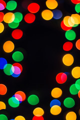 Colorful bokeh on a black background. New Year, Christmas wallpaper