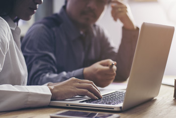 Image of business woman's hands typing in the office.