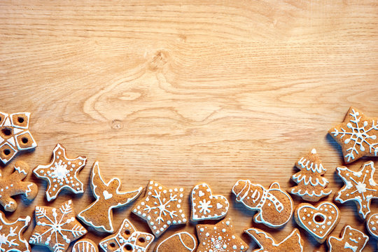 Christmas background with Gingerbread cookies on wooden table. Copy space for your text. Top view