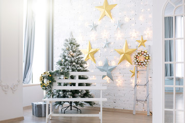 Christmas morning. The light room with Christmas scenery and a fir-tree. New Year scene.