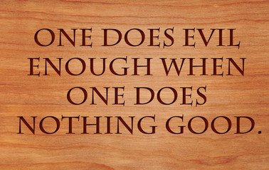 One does evil enough when one does nothing good - German Proverb on wooden red oak background