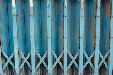 The blue rusty steel door background. Old style of closed blue steel door