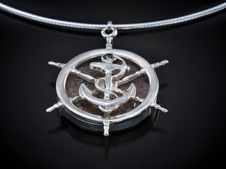 silver necklace with ashes isolated on black