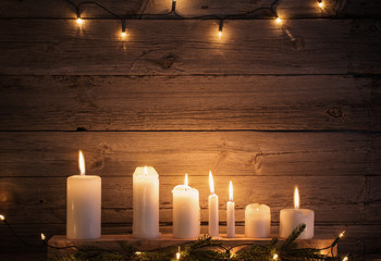 Christmas candles on wooden background