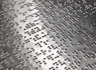 Braille Text Writing on iron plate background/Selective focus and Close up
