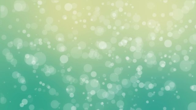 Bokeh holiday background with flickering bubbles against a gradient teal yellow green backdrop
