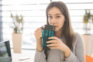 Beautiful businesswoman drinking tea