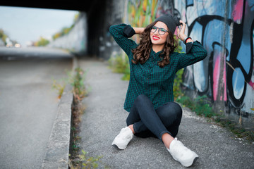 girl smiling on the street, background graffiti