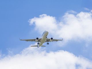 Fototapeta na wymiar Airplane flying under blue sky 3