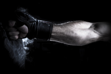 Male Athlete boxer punching a punching bag with dramatic edgy li