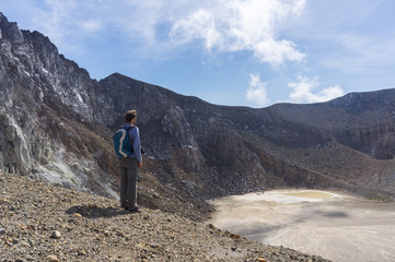 Tourist standing in the crater of Mount Egon, Flores, Nusa Tenggara, Indonesia