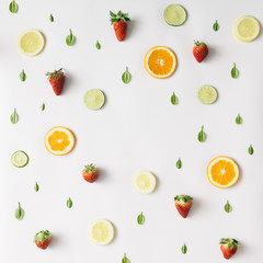 Colorful pattern made of citrus fruits and strawberries. Flat la