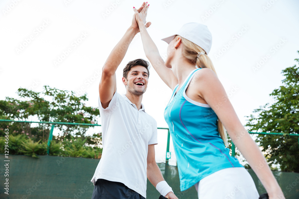 Wall mural happy young tennis players