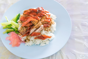 roasted duck in juicy sauce with rice, Steamed rice with roast duck on linoleum plate
