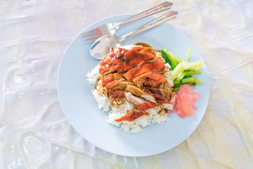 roasted duck in juicy sauce with rice, Steamed rice with roast duck on linoleum plate
